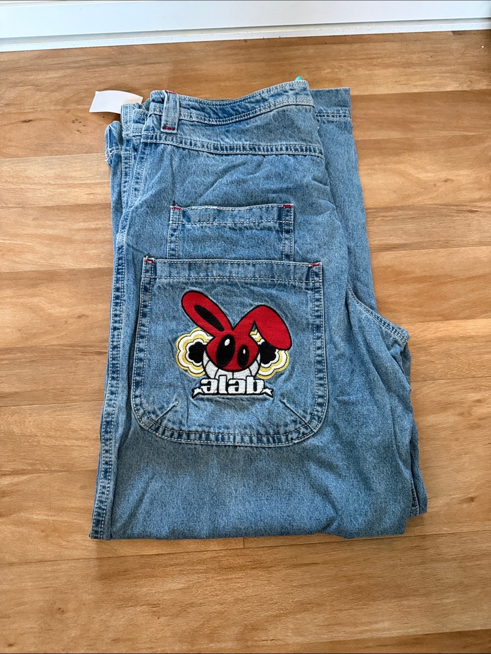 Men's Light Blue Denim Jeans with Red Graphic Patch